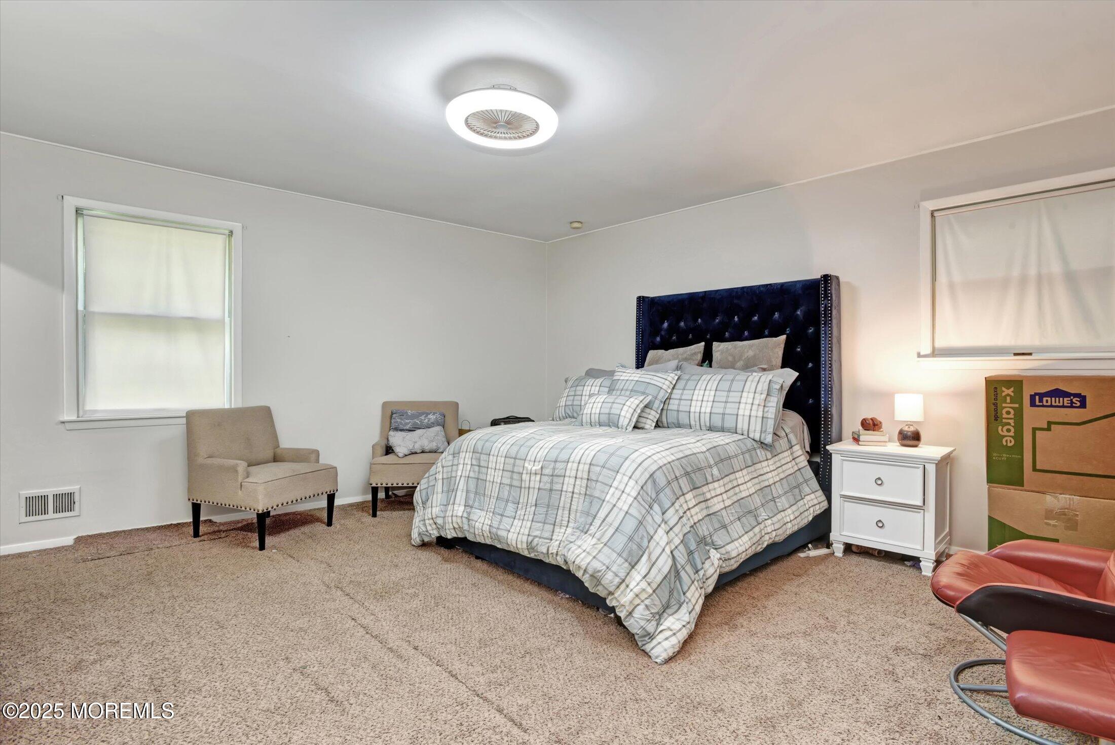 10 Bowman Road Jackson, NJ 08527 - Photo 19 of 32 a spacious bedroom with a bed and a chair