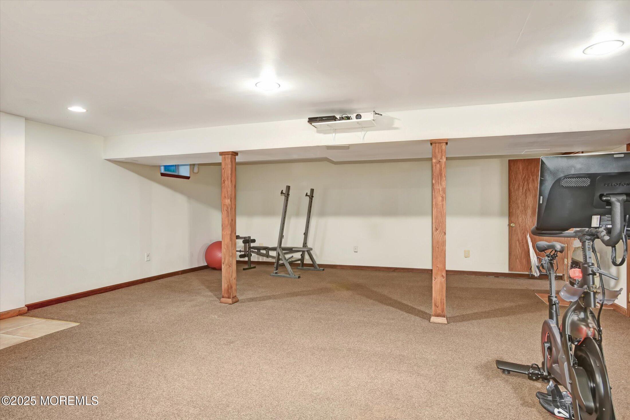 10 Bowman Road Jackson, NJ 08527 - Photo 22 of 32 an empty room with wooden floor and gym equipment