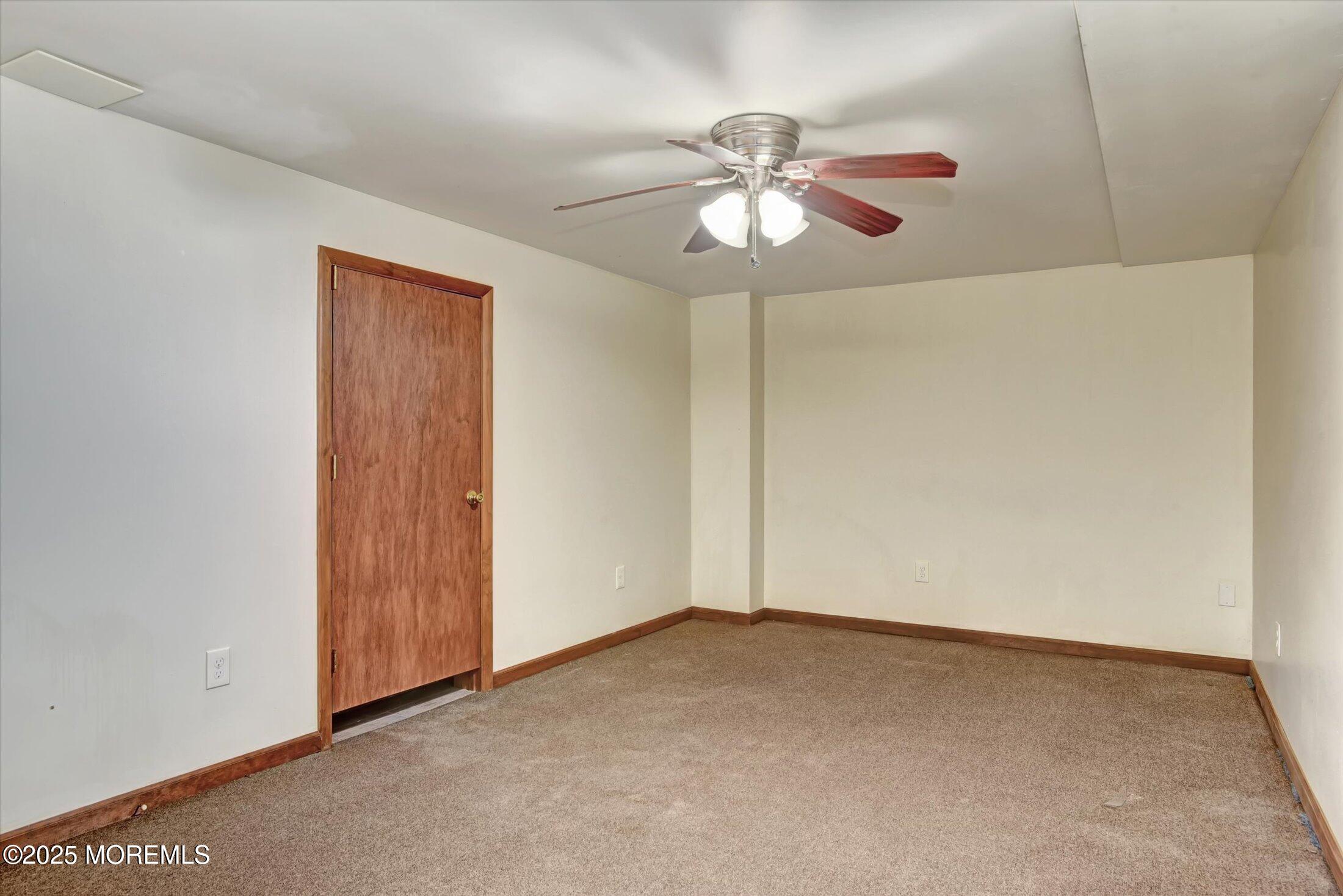 10 Bowman Road Jackson, NJ 08527 - Photo 25 of 32 an empty room with a chandelier fan