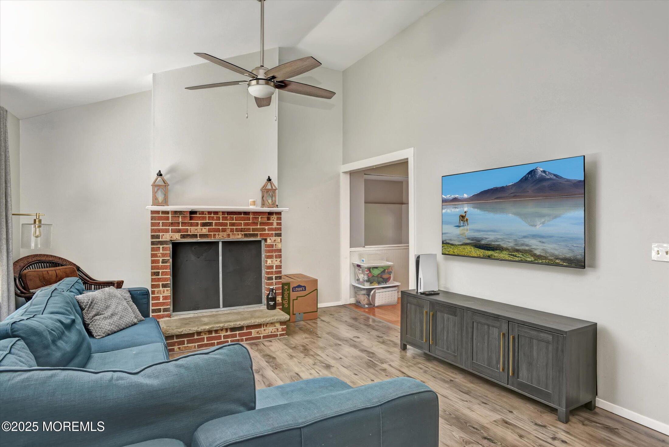 10 Bowman Road Jackson, NJ 08527 - Photo 3 of 32 a living room with furniture a fireplace and a flat screen tv
