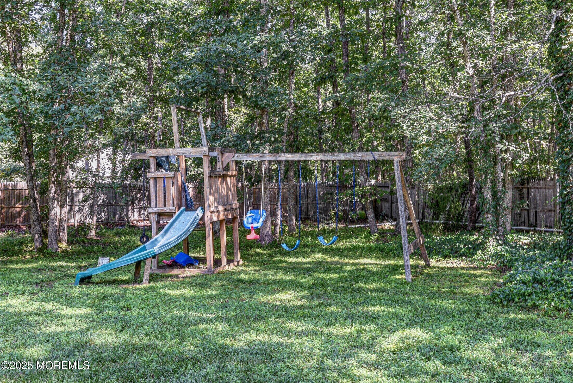 10 Bowman Road Jackson, NJ 08527 - Photo 32 of 32 a view of a backyard with a slide and a child swing