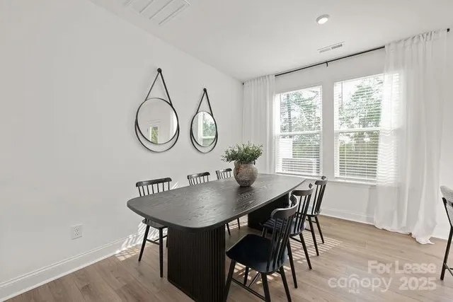 a view of a dining room with furniture and window