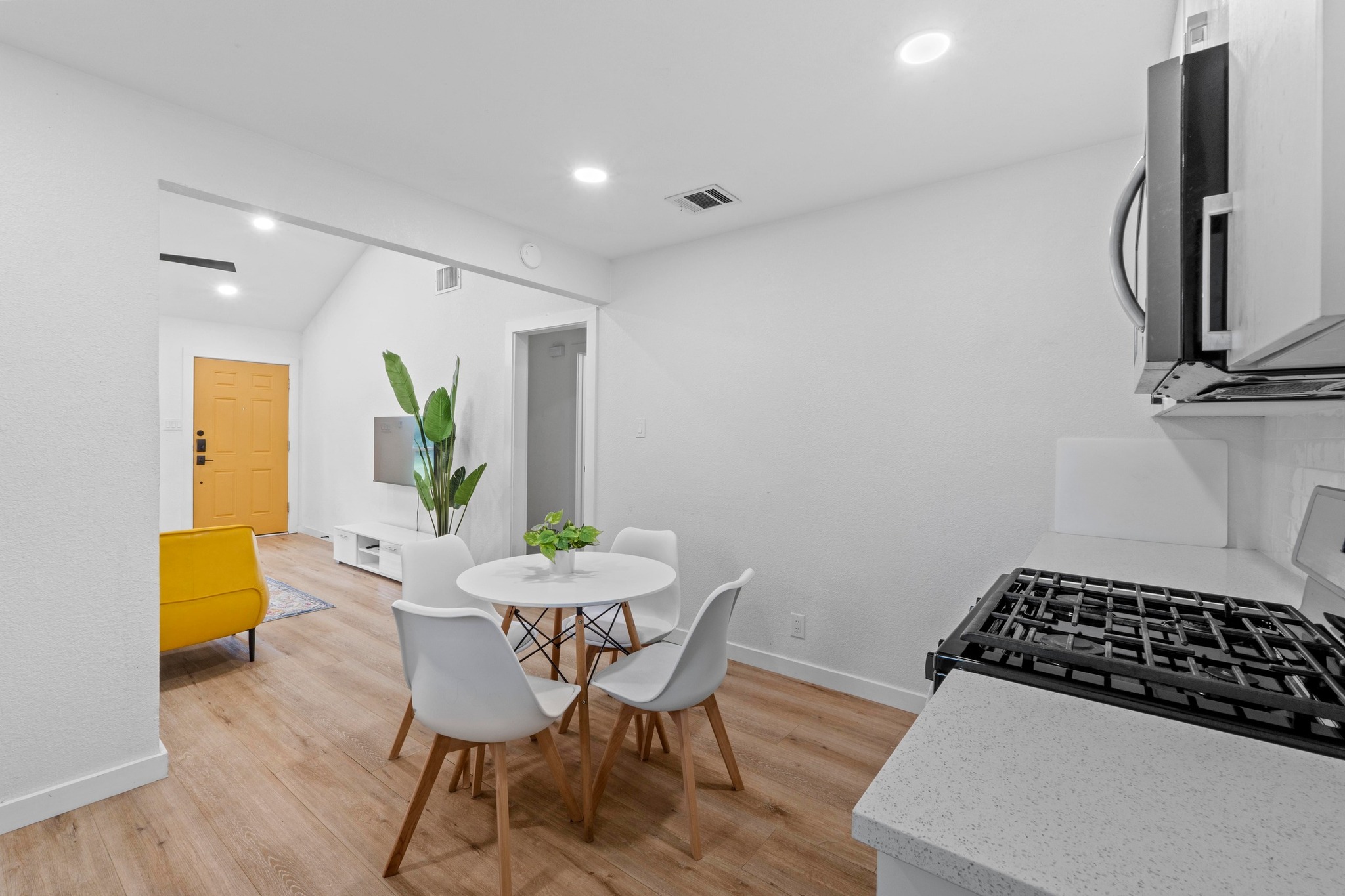10601 Macmora Road, Unit B Austin, TX 78758 - Photo 22 of 22 An open floor plan with hardwood flooring flows into a modern kitchen.