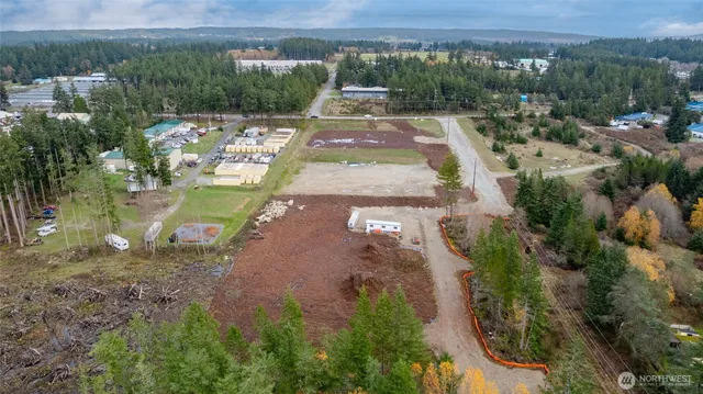 an aerial view of a house with a yard lake and outdoor space
