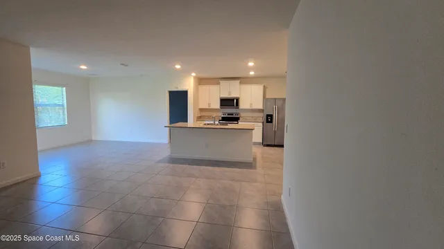a view of a kitchen with a sink and cabinets