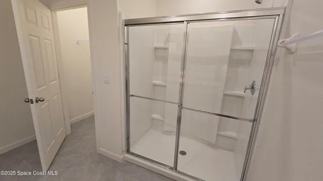 a bathroom with a glass shower door
