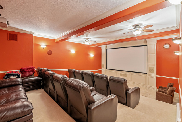 4093 North Imperial Way Provo, UT 84604 - Photo 47 of 96 Dedicated home theater featuring a large projection screen, coffered ceiling, ceiling fans, wall sconces, and tiered seating