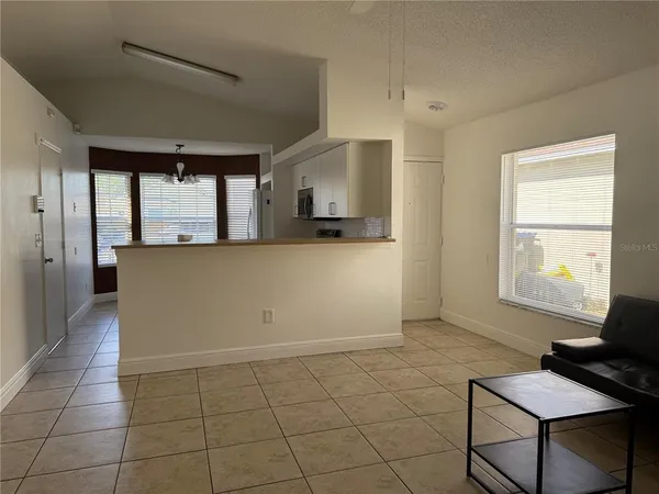 a view of kitchen with windows and cabinet