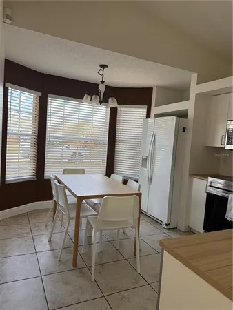a dining room with furniture and window