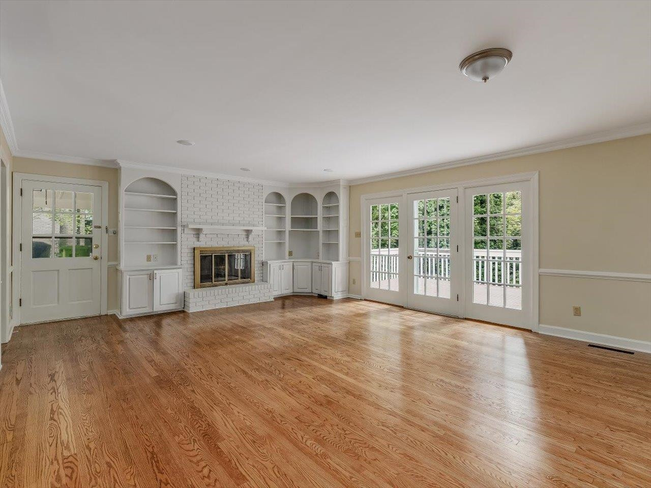 4725 Oak Park Road Raleigh, NC 27612 - Photo 14 of 75 a view of empty room with wooden floor and fireplace