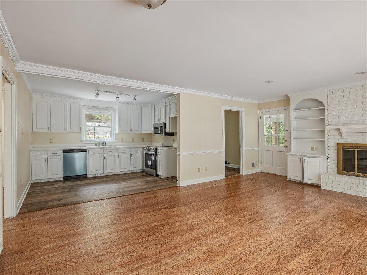 4725 Oak Park Road Raleigh, NC 27612 - Photo 24 of 75 a view of a kitchen with a sink a stove top oven and cabinets