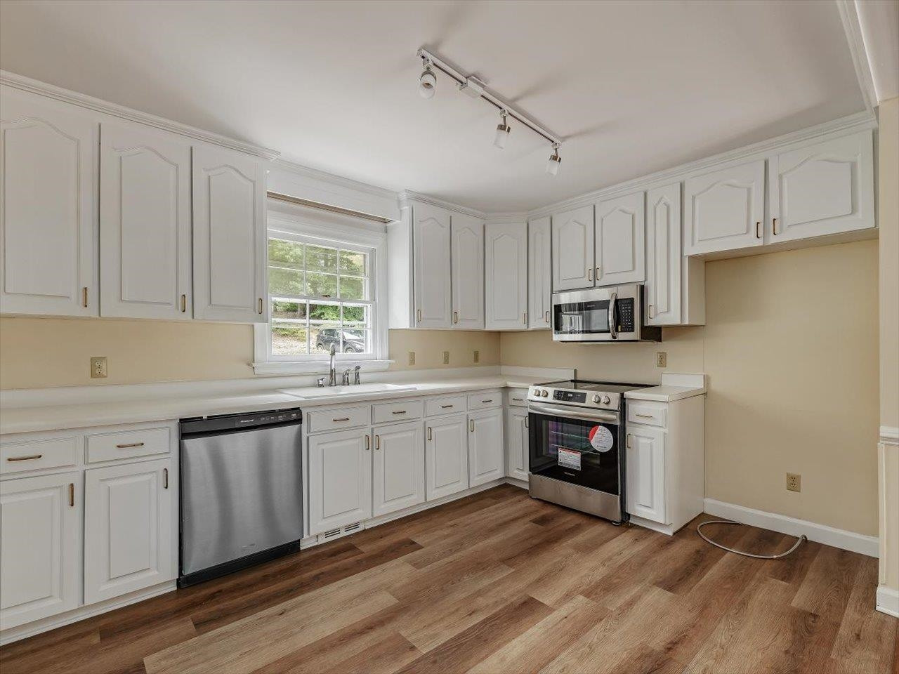 4725 Oak Park Road Raleigh, NC 27612 - Photo 26 of 75 a kitchen with granite countertop white cabinets and white appliances
