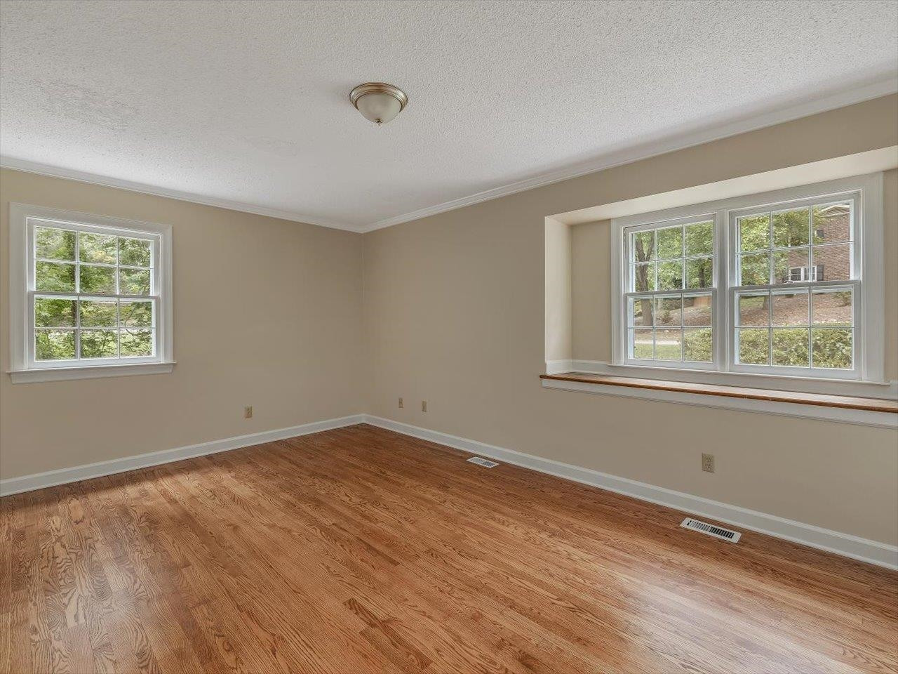 4725 Oak Park Road Raleigh, NC 27612 - Photo 29 of 75 a view of an empty room with wooden floor and a window
