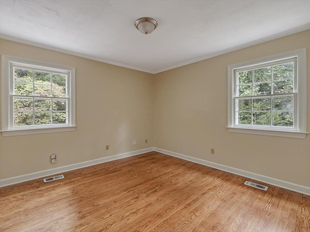 4725 Oak Park Road Raleigh, NC 27612 - Photo 33 of 75 a view of an empty room with wooden floor and a window