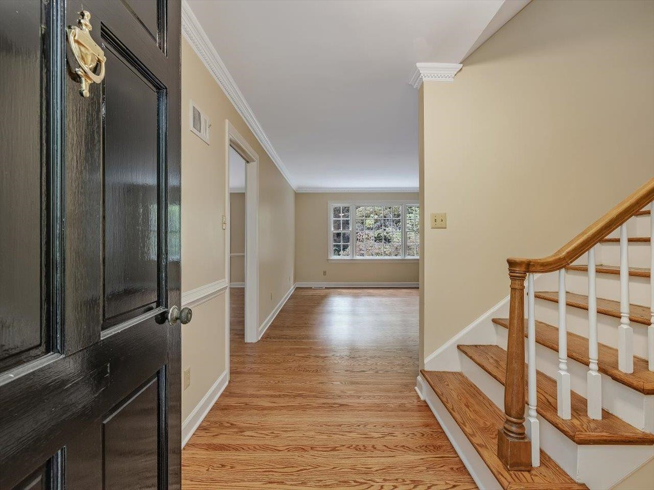 4725 Oak Park Road Raleigh, NC 27612 - Photo 10 of 75 a view of a hallway with wooden floor and staircase