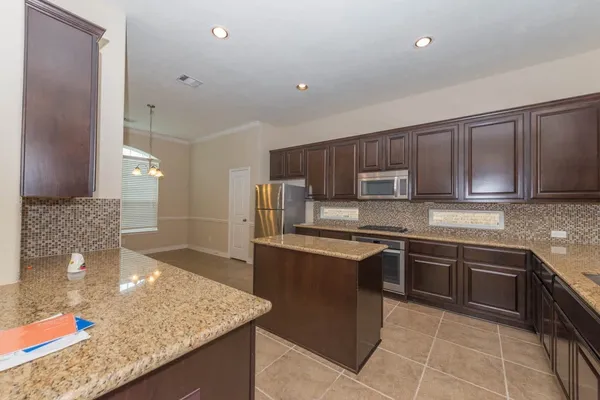 a kitchen with stainless steel appliances granite countertop a sink and stove