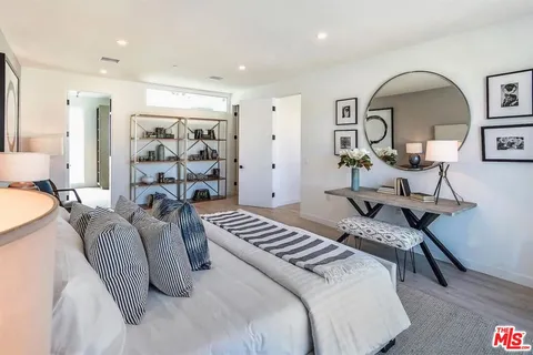 a bedroom with furniture and a wooden floor