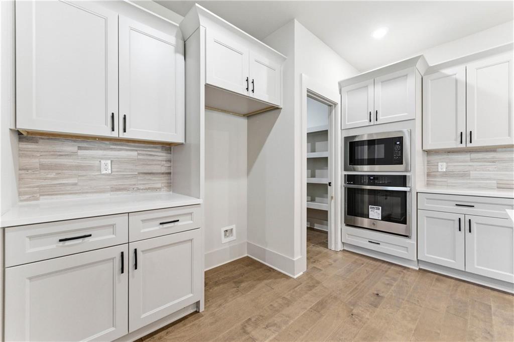 158 Races Road Hoschton, GA 30548 - Photo 15 of 24 a kitchen with white cabinets and stainless steel appliances