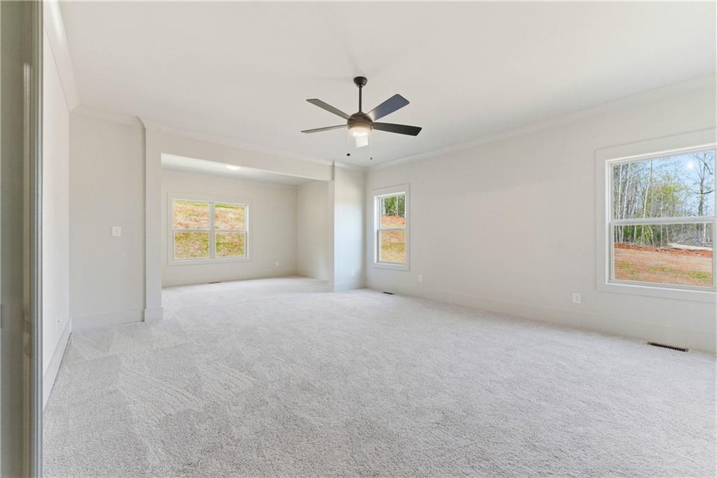 158 Races Road Hoschton, GA 30548 - Photo 17 of 24 an empty room with windows and fan