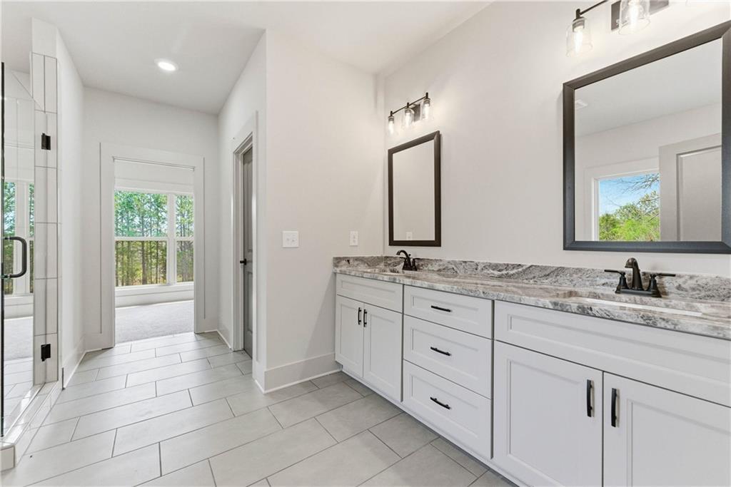 158 Races Road Hoschton, GA 30548 - Photo 18 of 24 a bathroom with a granite countertop sink and a mirror