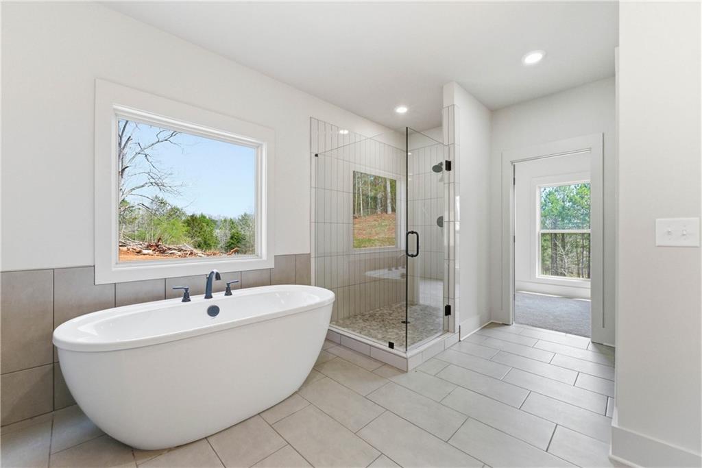 158 Races Road Hoschton, GA 30548 - Photo 19 of 24 a white bath tub sitting next to a bathroom sink