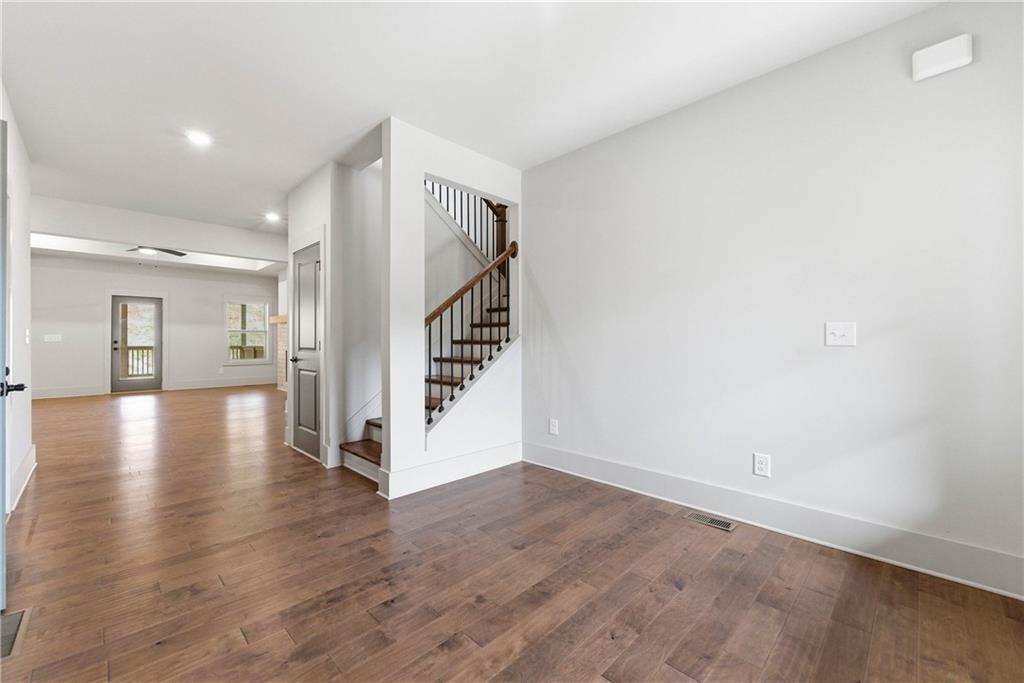158 Races Road Hoschton, GA 30548 - Photo 5 of 24 a view of a hallway with wooden floor and staircase