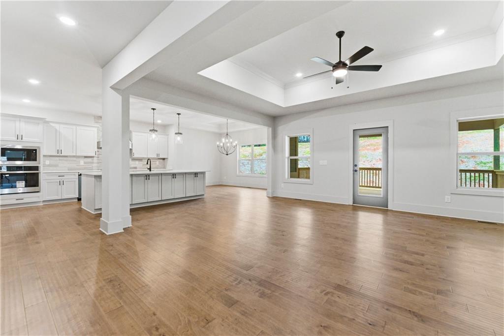 158 Races Road Hoschton, GA 30548 - Photo 6 of 24 a view of a livingroom with a flat screen tv wooden floor and window