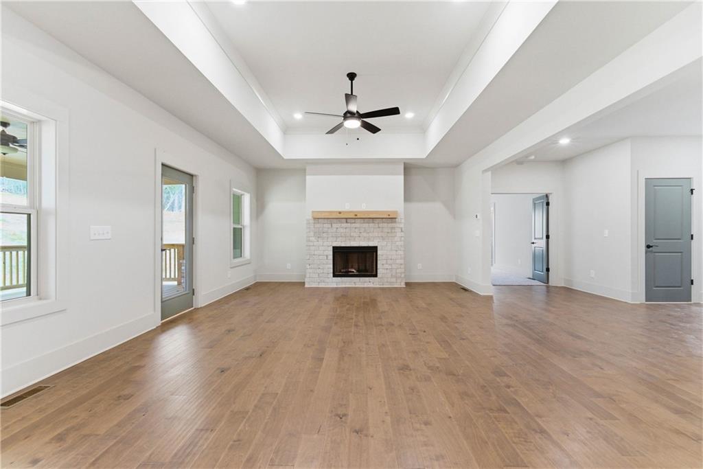158 Races Road Hoschton, GA 30548 - Photo 7 of 24 an empty room with windows and fireplace