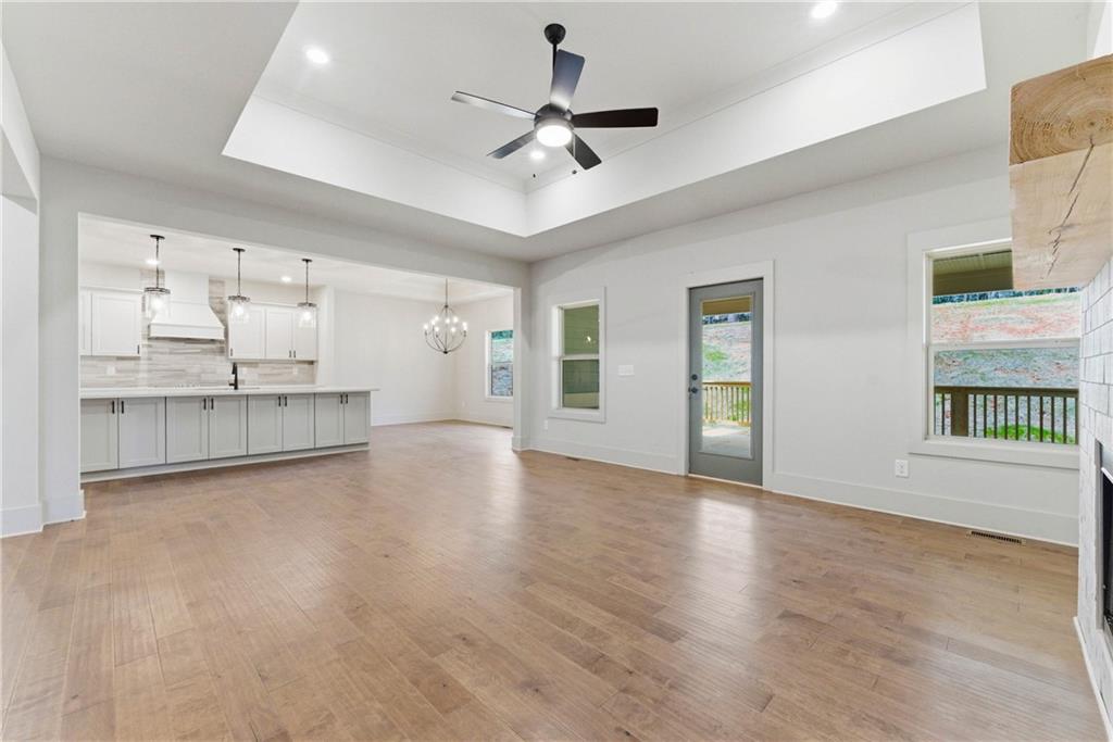 158 Races Road Hoschton, GA 30548 - Photo 8 of 24 a view of an empty room with a window and kitchen view