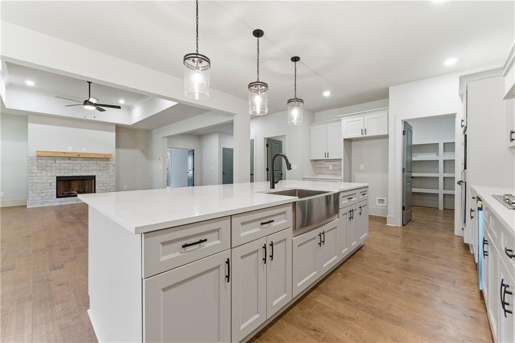 158 Races Road Hoschton, GA 30548 - Photo 10 of 24 a large white kitchen with a large kitchen island white cabinets and stainless steel appliances