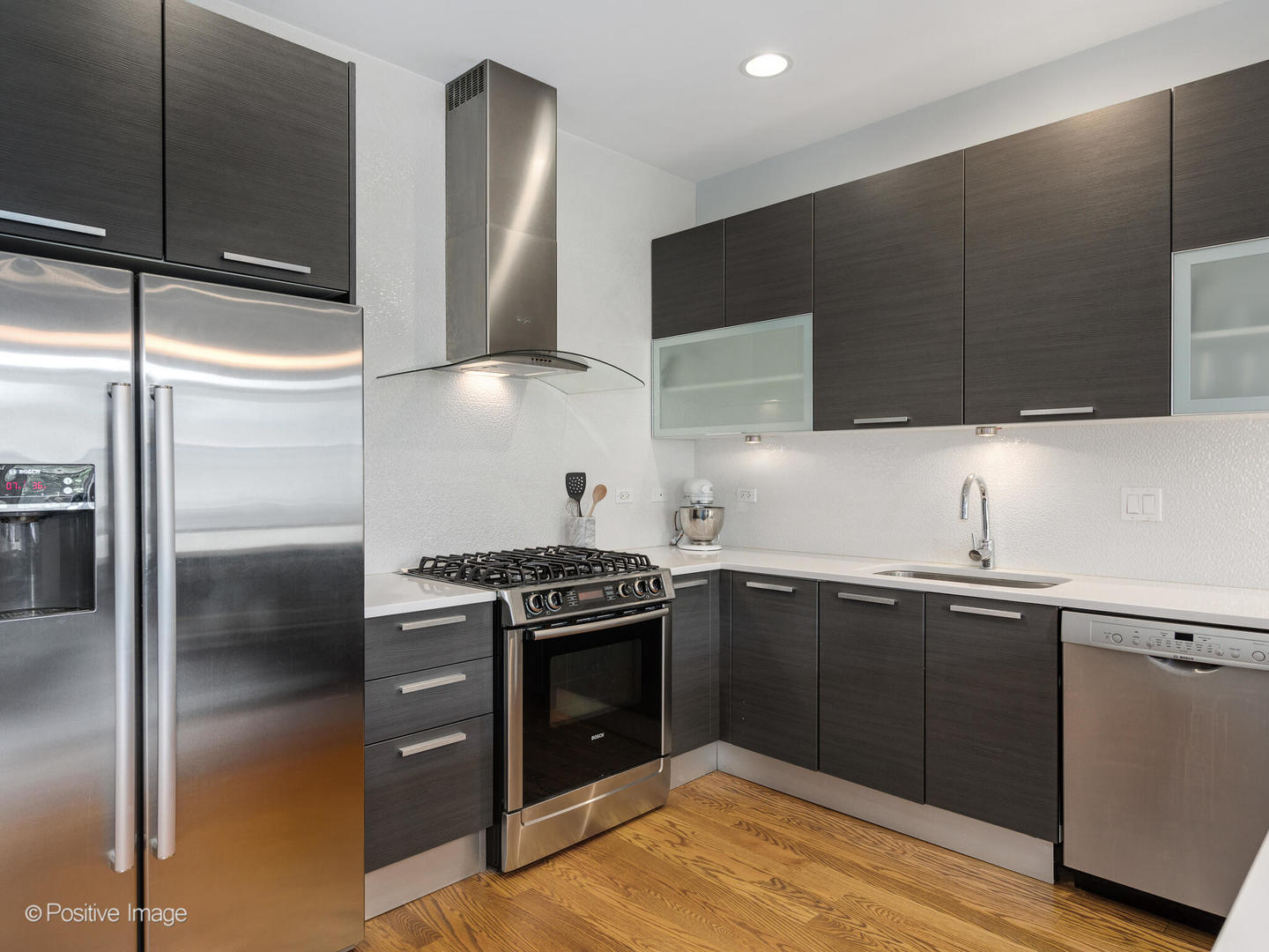 2128 West Rice Street, Unit 3 Chicago, IL 60622 - Photo 12 of 23 a kitchen with stainless steel appliances granite countertop a sink stove and refrigerator