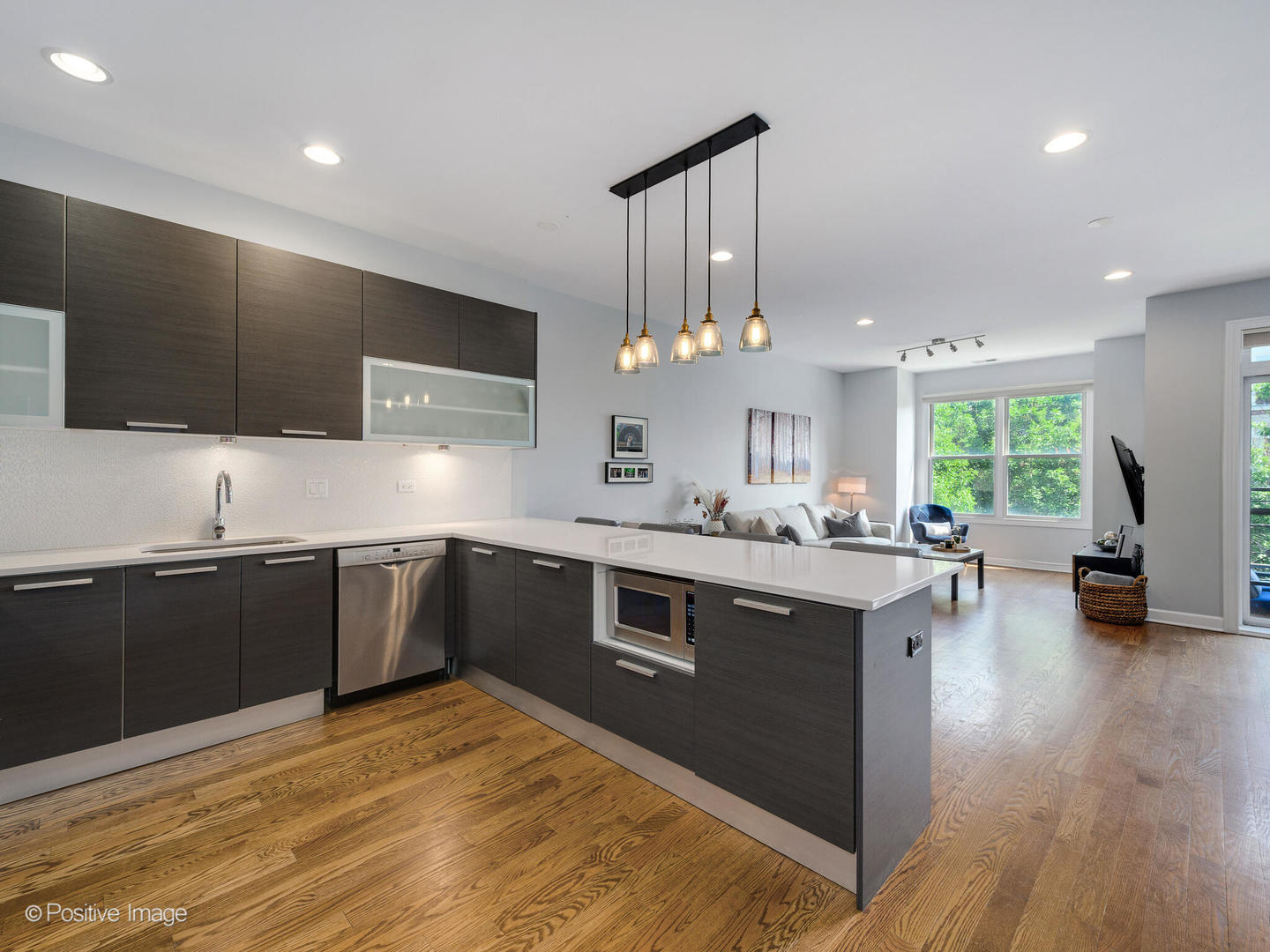 2128 West Rice Street, Unit 3 Chicago, IL 60622 - Photo 2 of 23 a kitchen with stainless steel appliances granite countertop a sink cabinets and wooden floor