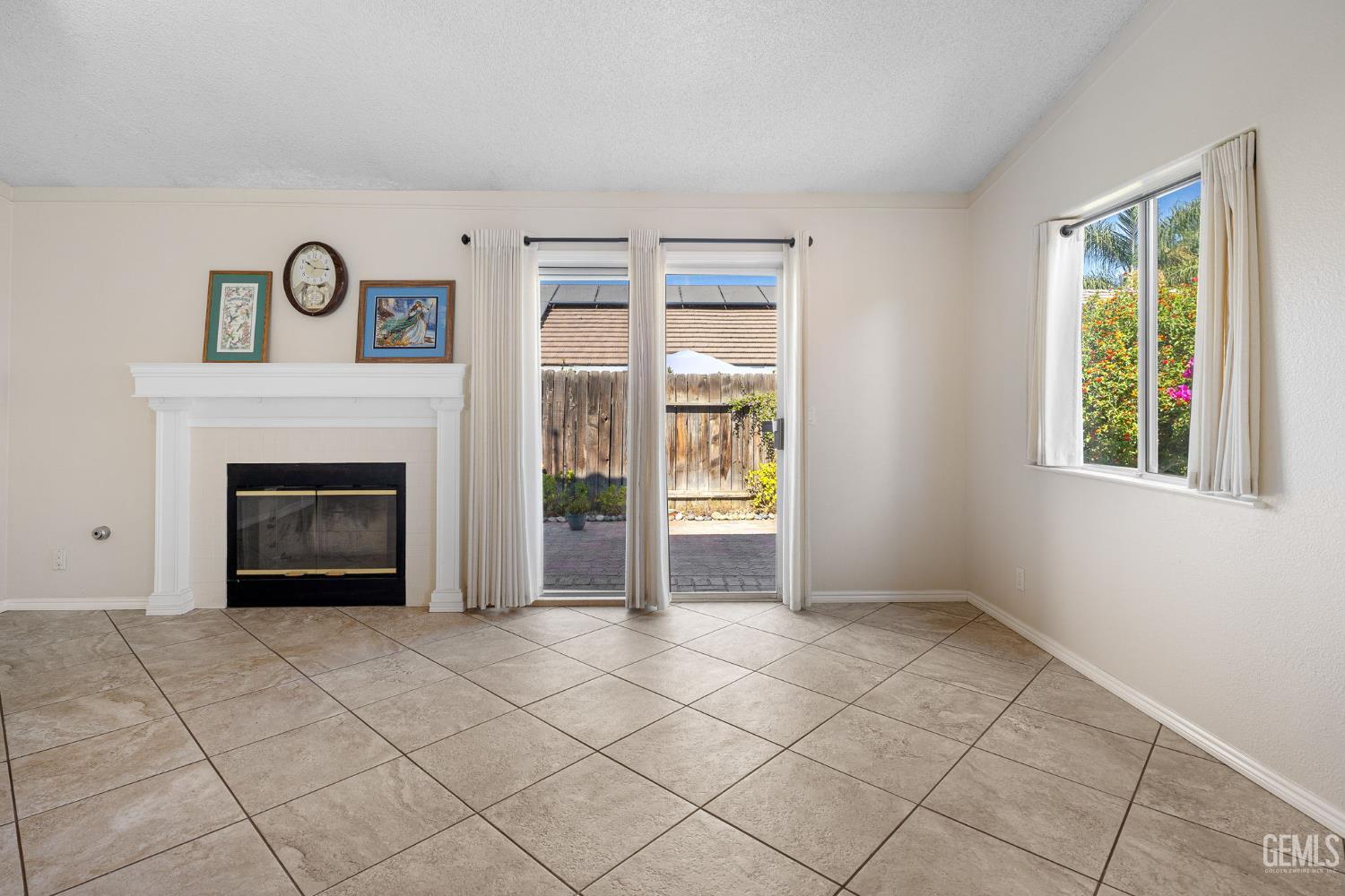 Undisclosed Address Bakersfield, CA 93312 - Photo 13 of 40 a view of an empty room with window and fire place