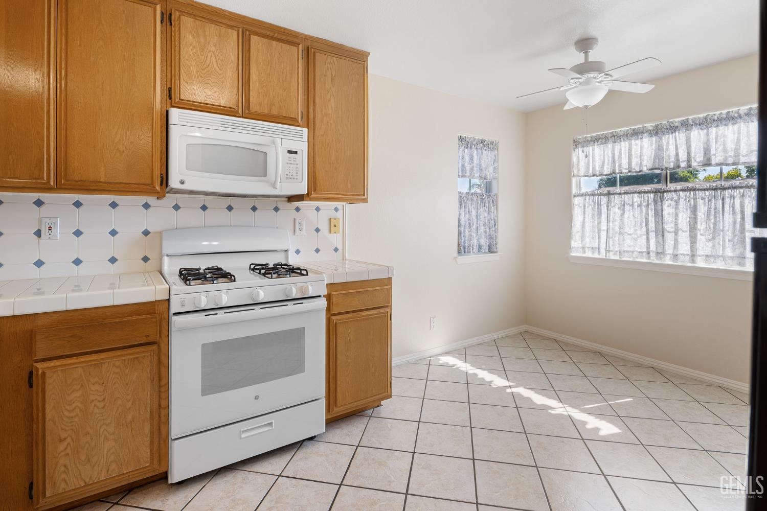 Undisclosed Address Bakersfield, CA 93312 - Photo 17 of 40 a kitchen with a stove top oven and sink