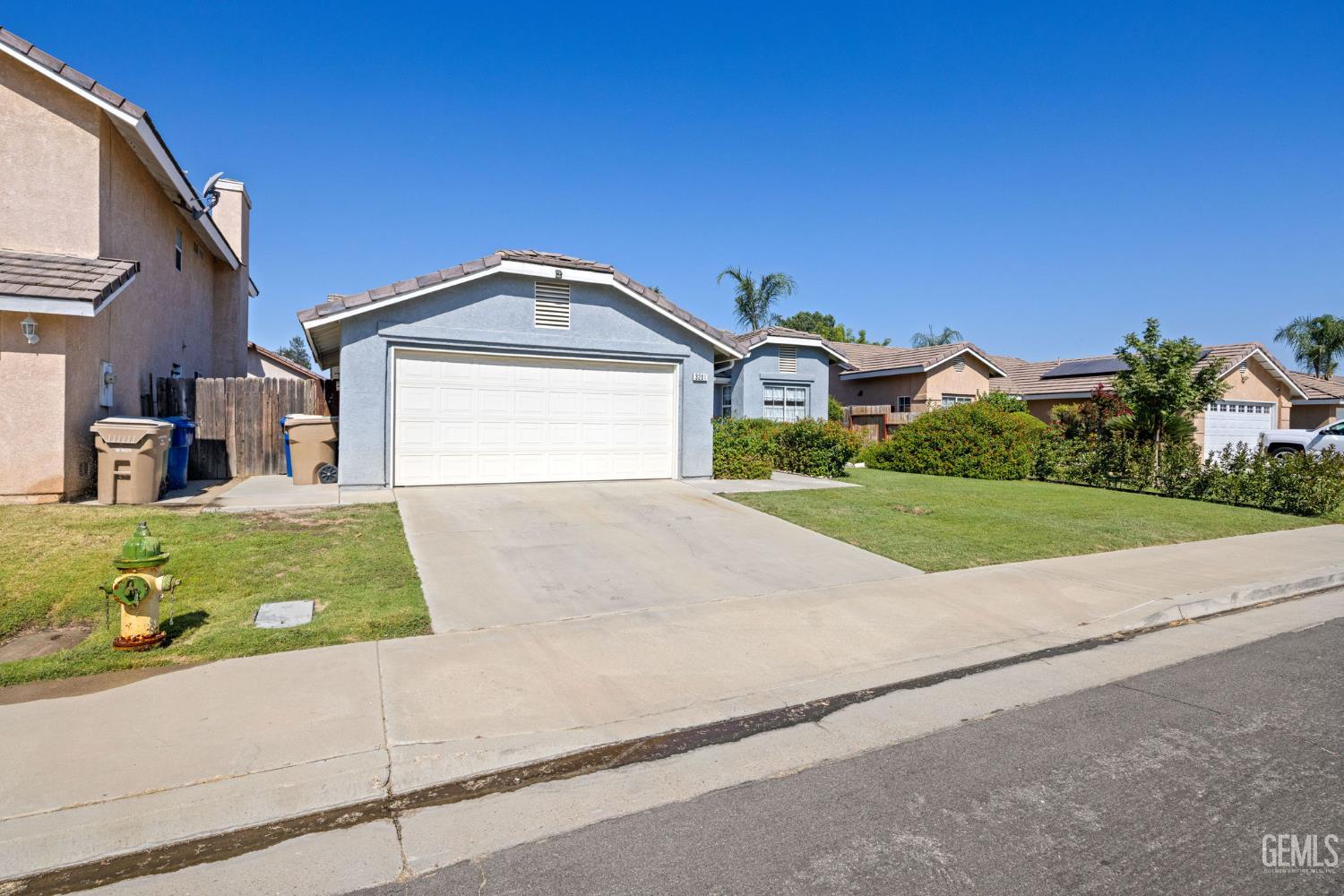 Undisclosed Address Bakersfield, CA 93312 - Photo 2 of 40 a front view of a house with a yard and garage