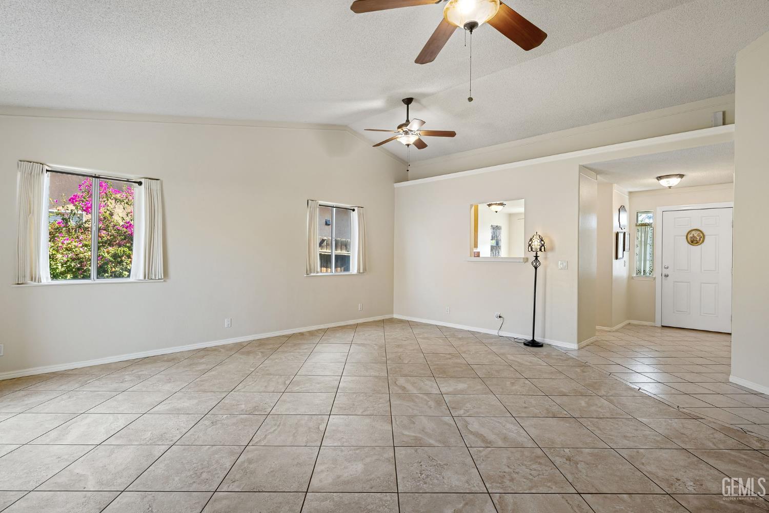Undisclosed Address Bakersfield, CA 93312 - Photo 8 of 40 a view of an empty room with window and chandelier fan