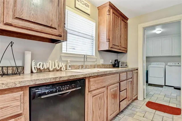 a kitchen with granite countertop a sink a stove and cabinets