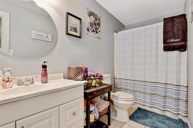 a bathroom with a sink toilet vanity and shower