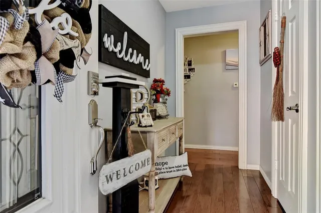 a view of a entryway with furniture and wooden floor