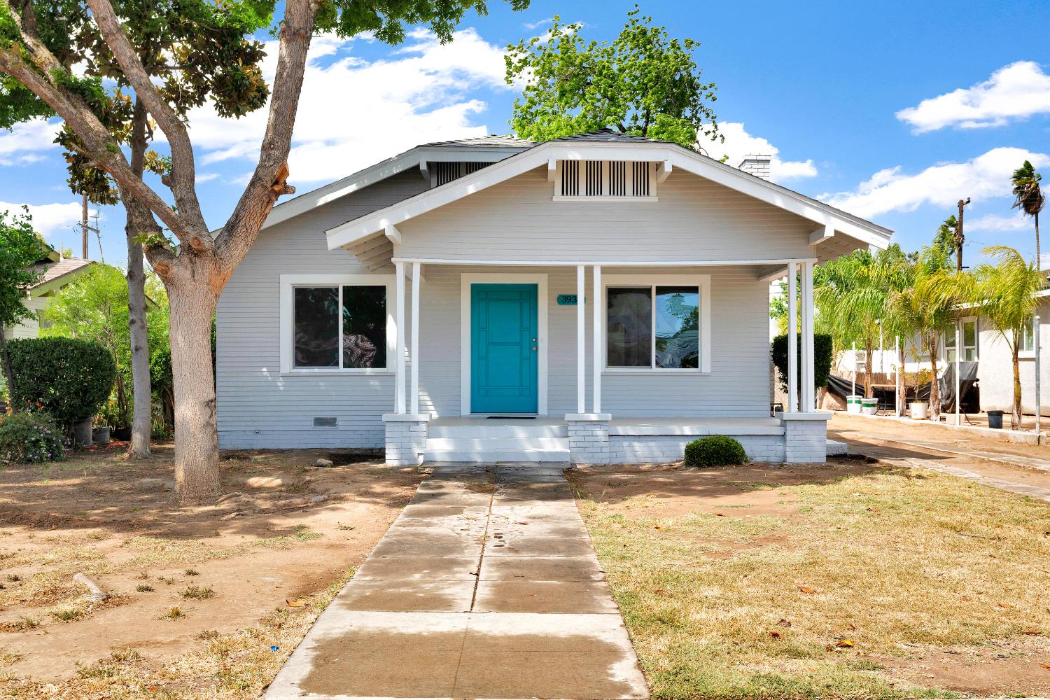 3935 East Balch Avenue Fresno, CA 93702 - Photo 1 of 25 a front view of a house with a yard