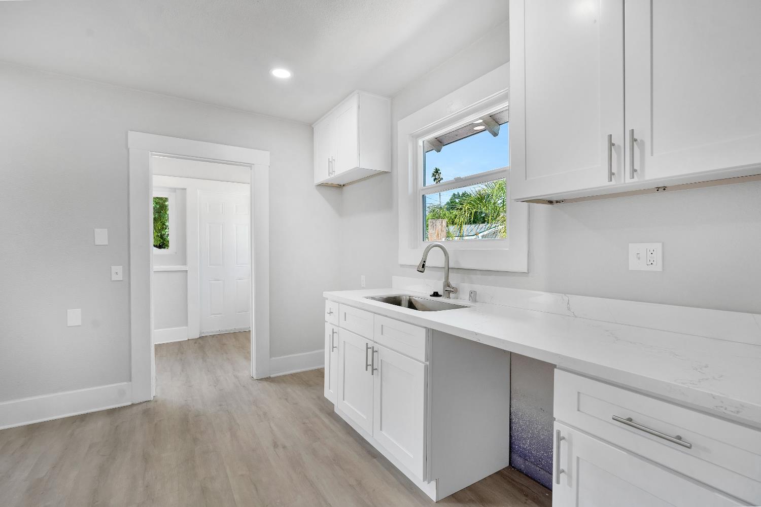 3935 East Balch Avenue Fresno, CA 93702 - Photo 12 of 25 a kitchen with sink cabinets and window