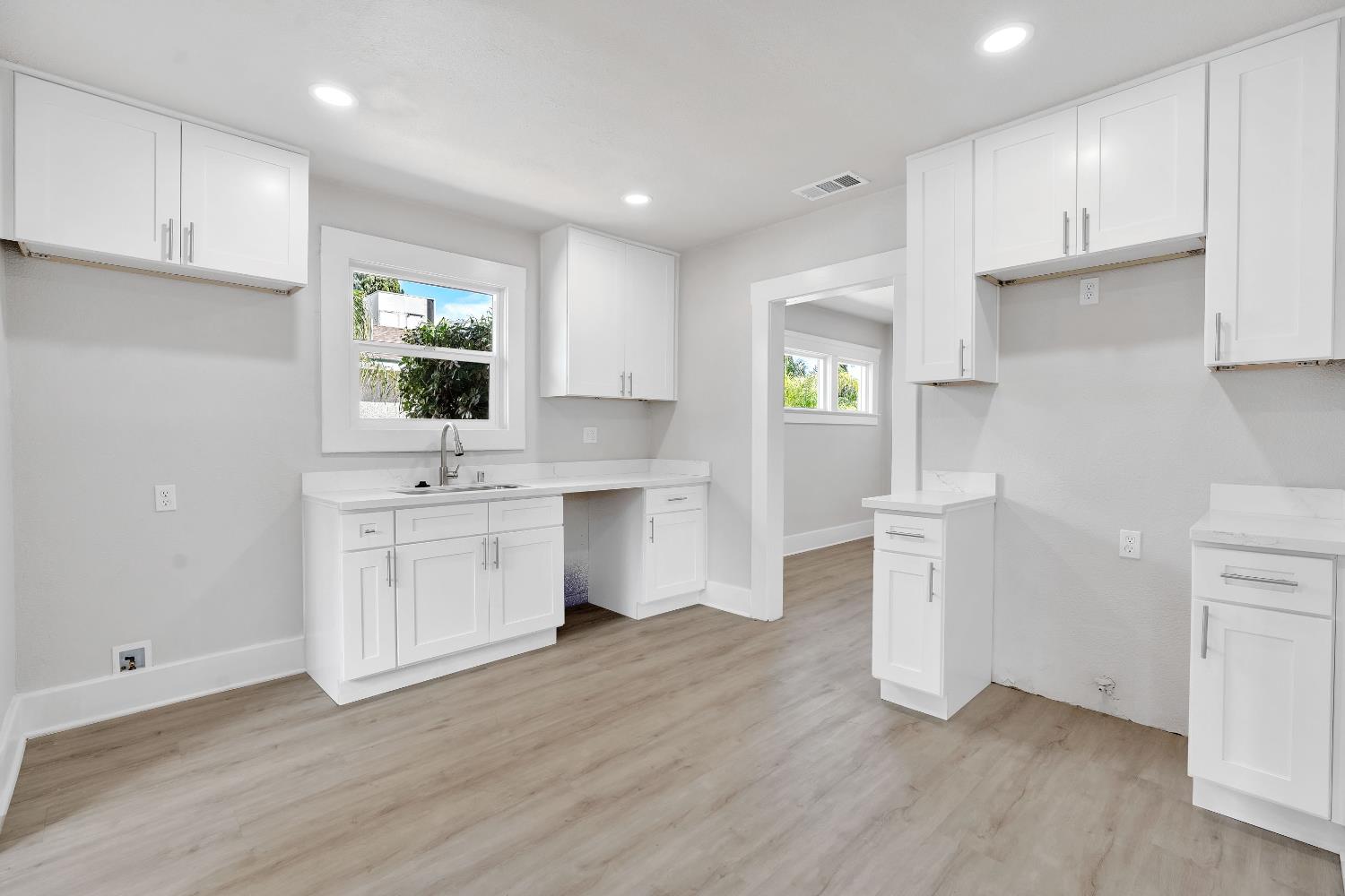 3935 East Balch Avenue Fresno, CA 93702 - Photo 15 of 25 a kitchen with a sink cabinets and window