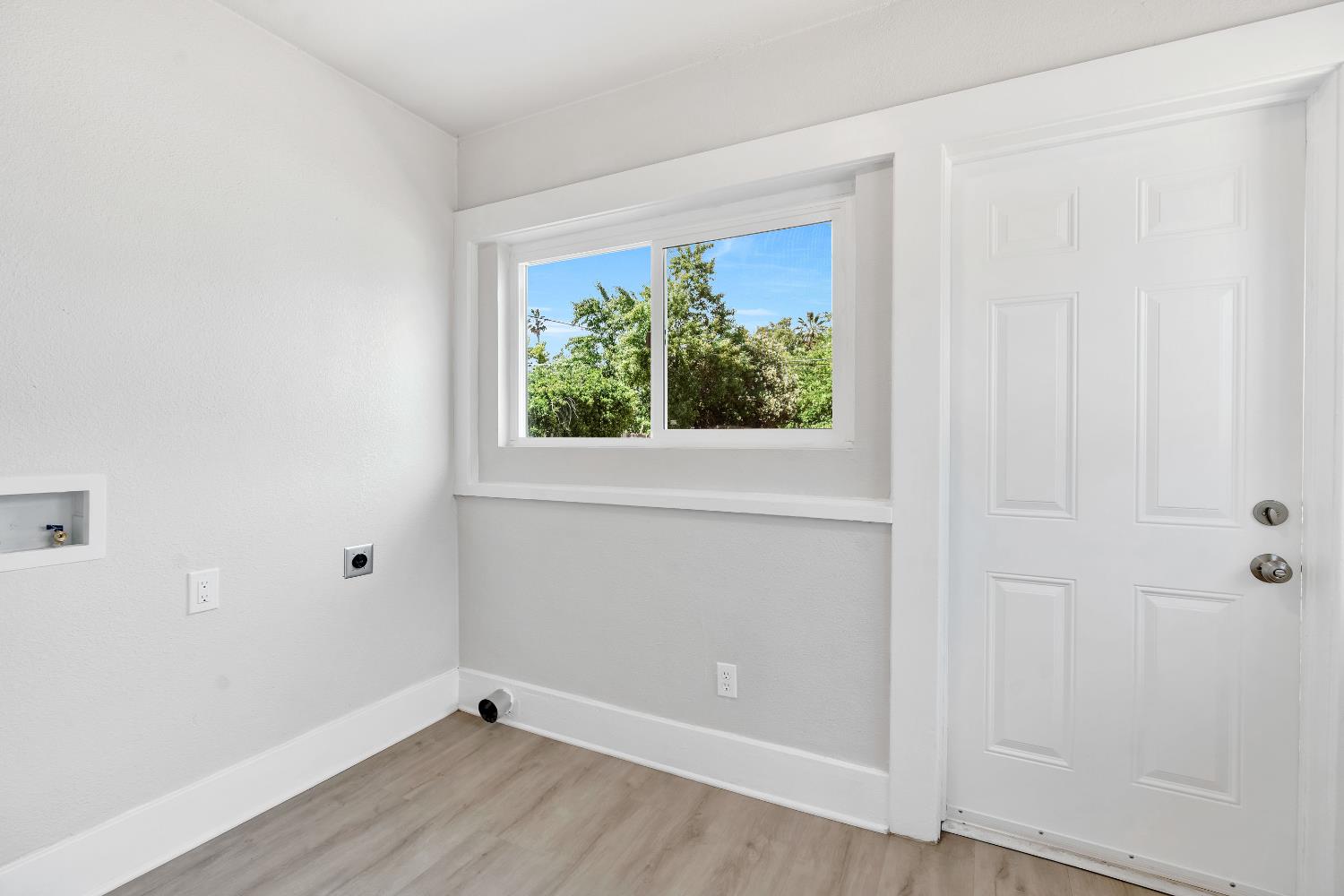 3935 East Balch Avenue Fresno, CA 93702 - Photo 17 of 25 an empty room with wooden floor and windows