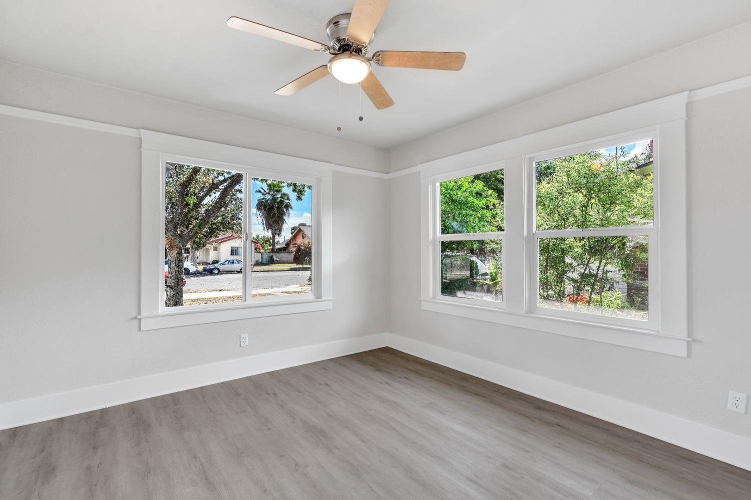 3935 East Balch Avenue Fresno, CA 93702 - Photo 18 of 25 a view of an empty room with wooden floor and a window