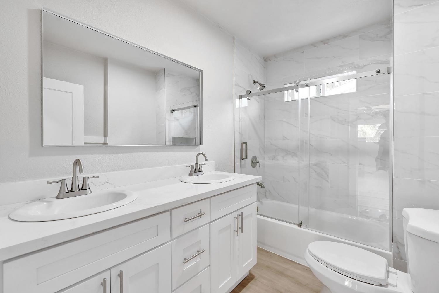 3935 East Balch Avenue Fresno, CA 93702 - Photo 20 of 25 a bathroom with a sink a toilet and shower