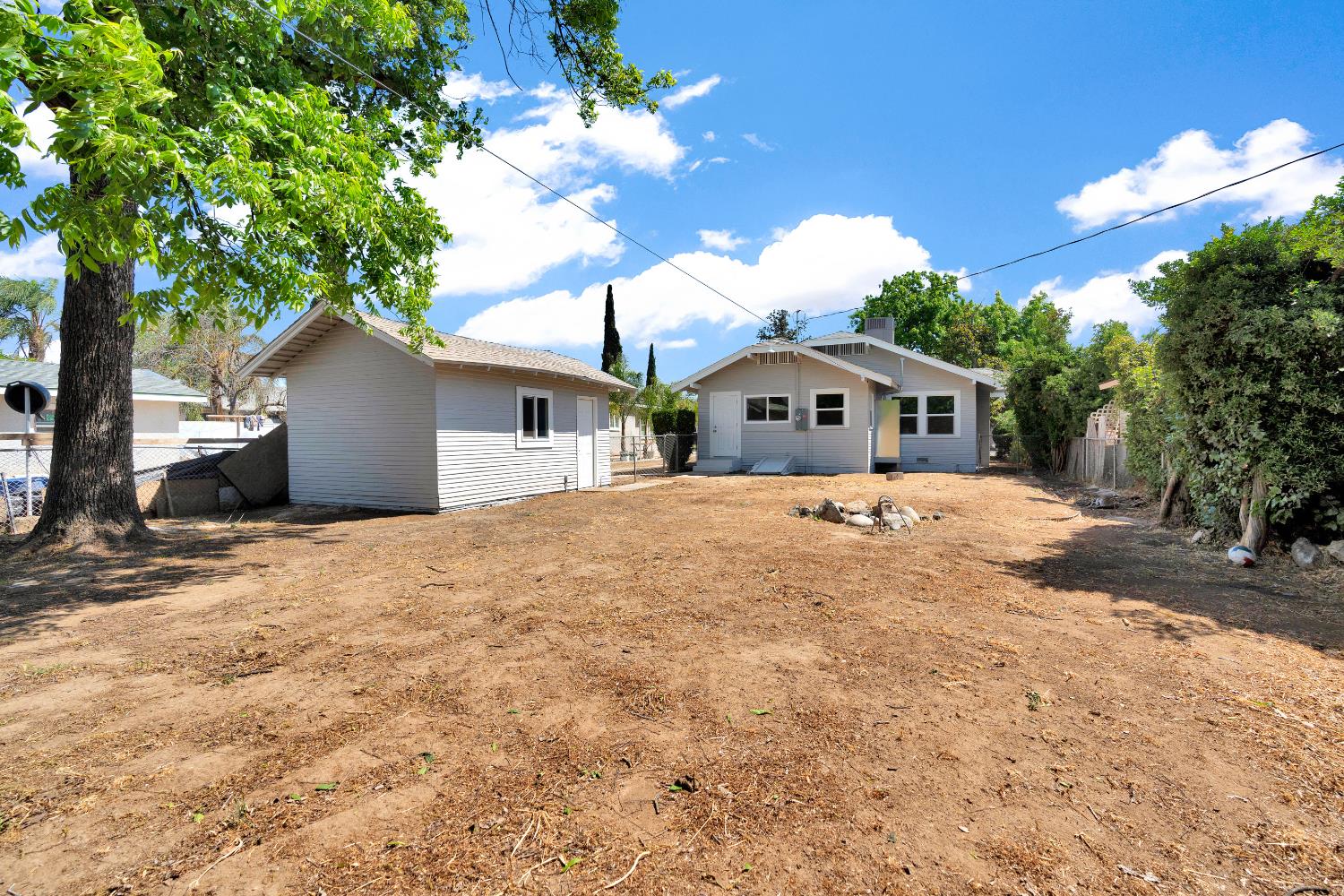3935 East Balch Avenue Fresno, CA 93702 - Photo 23 of 25 a front view of a house with a yard and garage