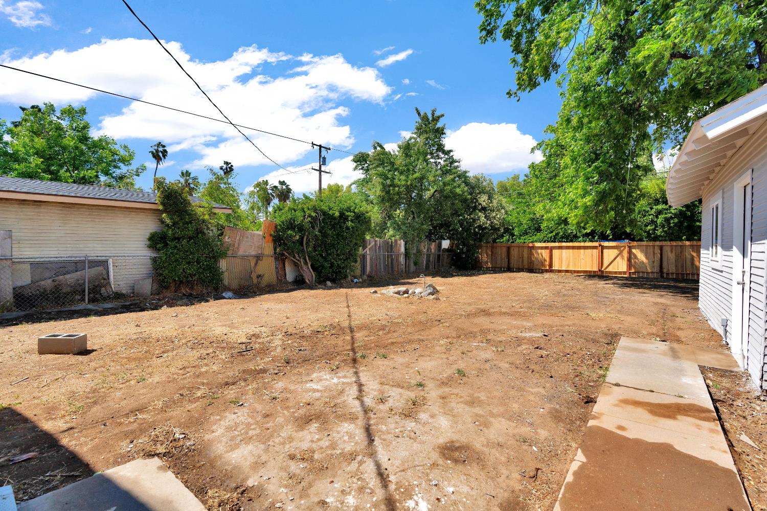 3935 East Balch Avenue Fresno, CA 93702 - Photo 24 of 25 a view of backyard with a garden and trees