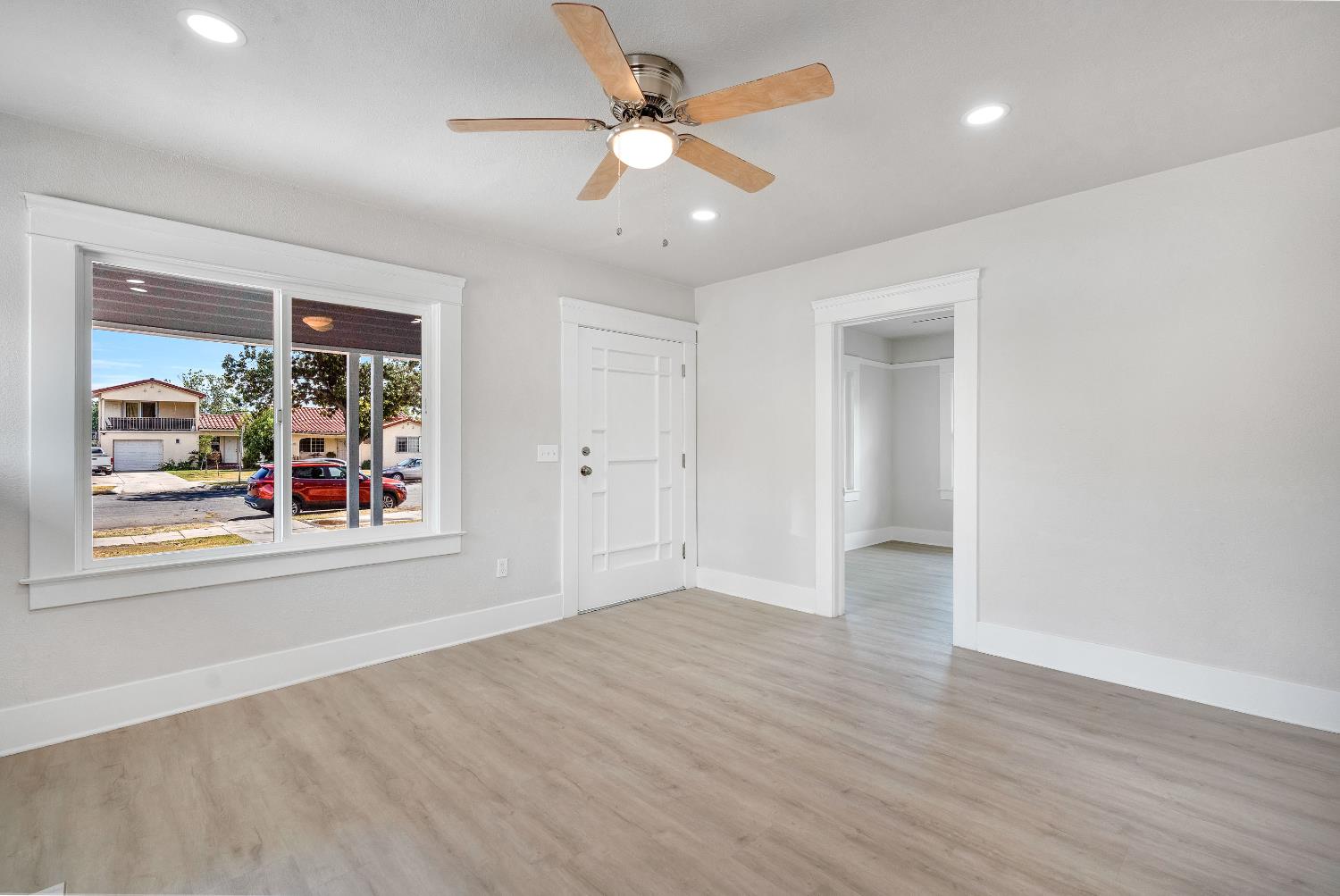 3935 East Balch Avenue Fresno, CA 93702 - Photo 7 of 25 wooden floor in an empty room with a window