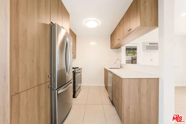 a kitchen with stainless steel appliances a refrigerator and a sink