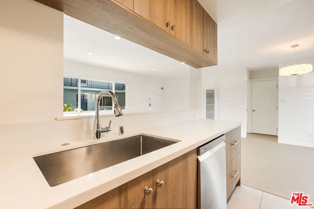 a kitchen with a sink a counter top space and cabinets